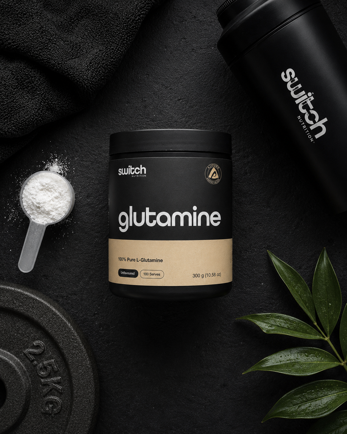 Glutamine powder container with scoop, weight plate, and leaves on a dark background