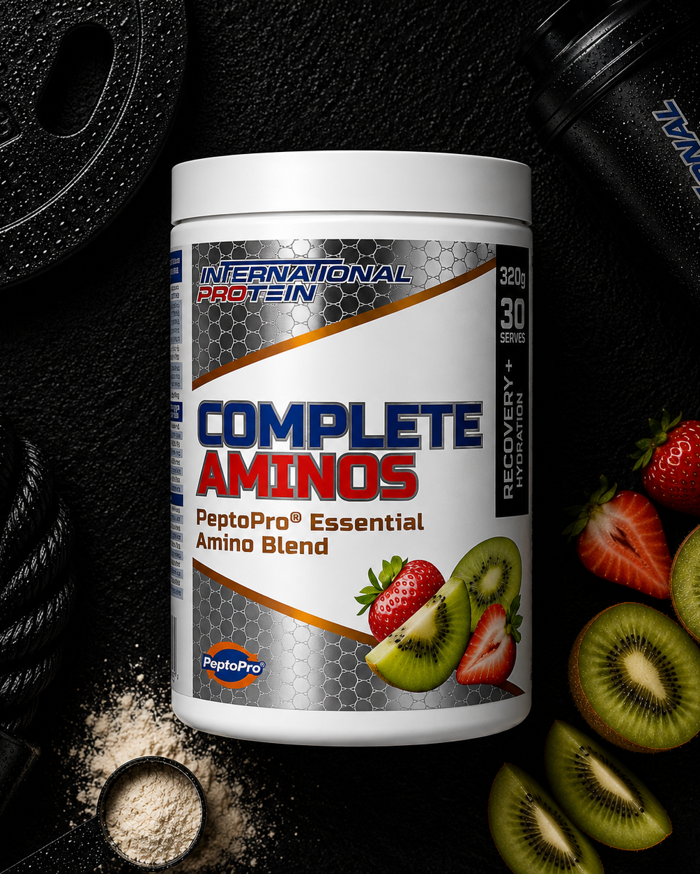 International Protein Complete Aminos supplement container with fruits and gym equipment on a dark background