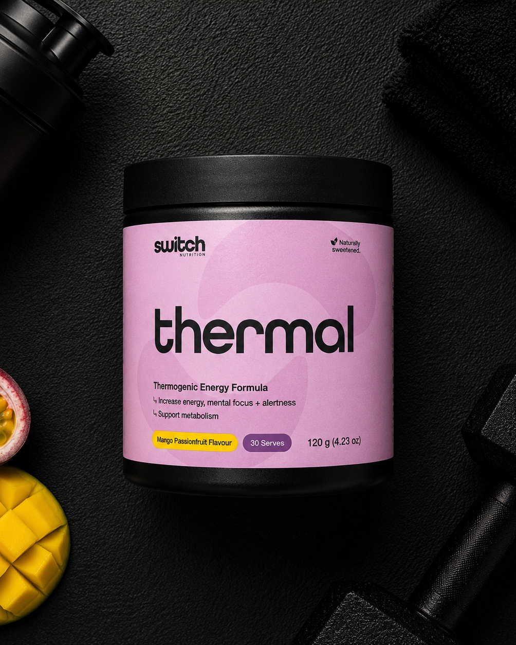 Purple container of 'thermal' energy formula by Switch Nutrition on a dark surface with a shaker and fruit.