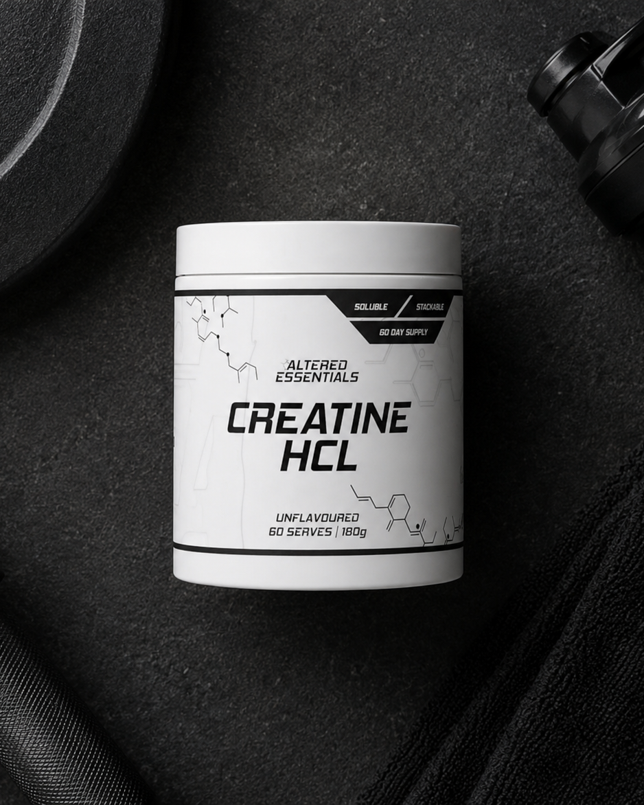 Container of Altered Essentials Creatine HCL on a dark surface with fitness equipment.