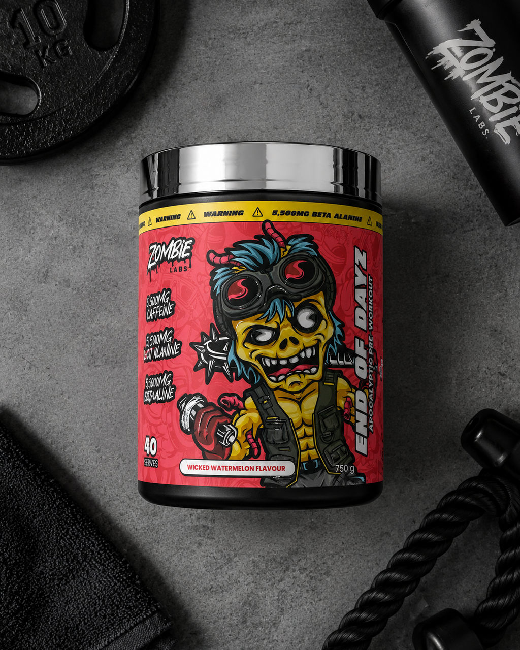 A tub of Zombie Labs End of Dayz muscle powder supplement, featuring a red label with a cartoon zombie graphic, styled on a dark gray textured background with gym equipment.