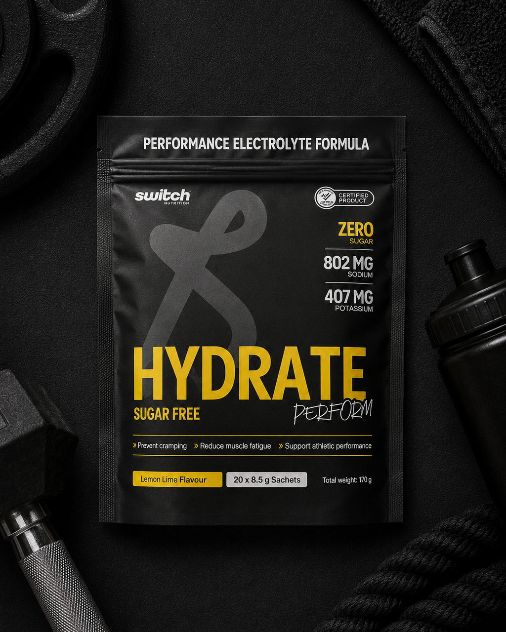 Black and yellow supplement package labeled 'Hydrate' on a dark background with fitness equipment.