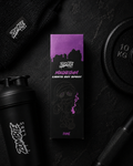 Zombie Labs Magnum Lights Out Spray packaging on a dark background with gym equipment.