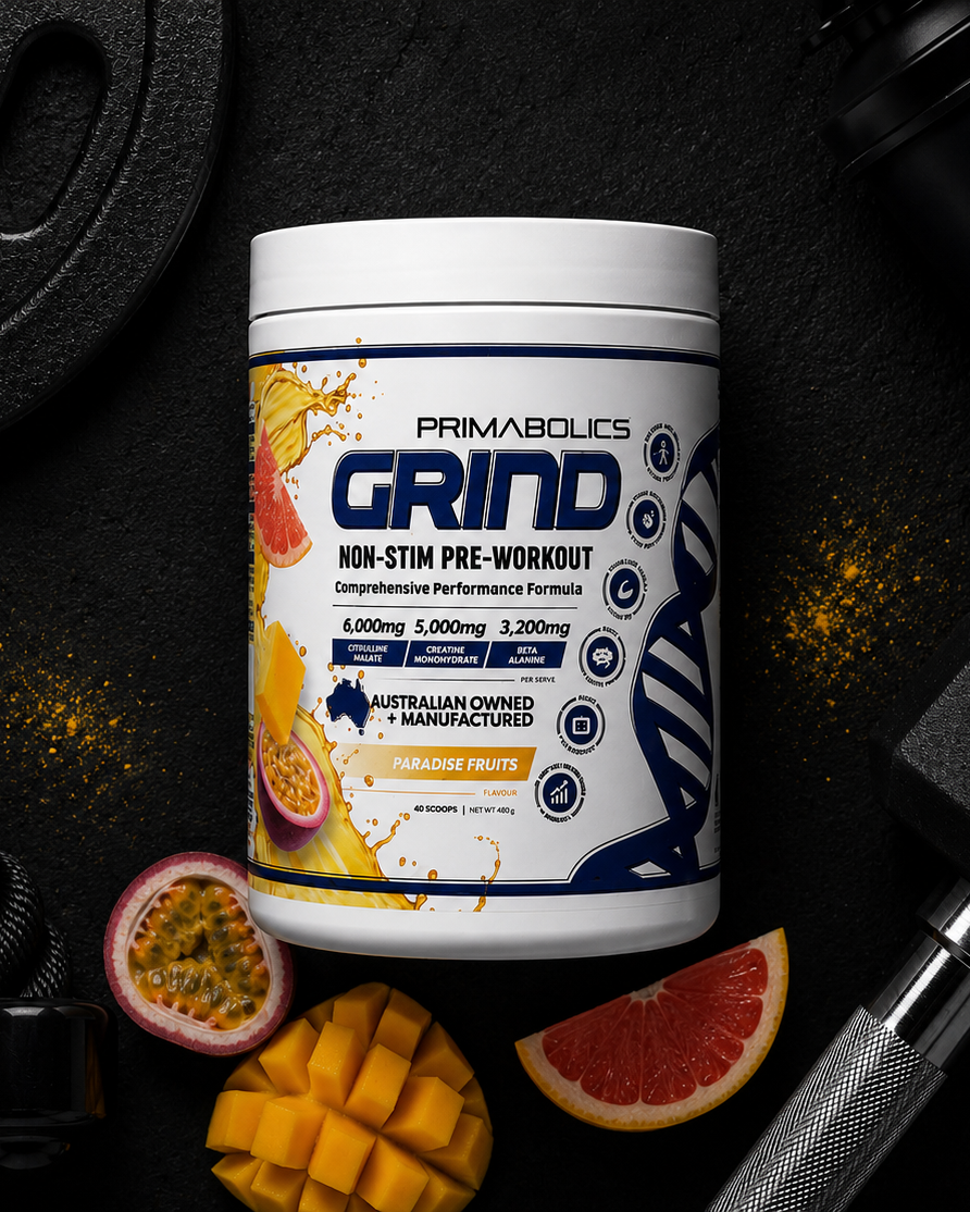 Primabolics Grind supplement container with gym equipment and fruits on a dark background