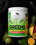 White Wolf Nutrition Greens supplement container with tropical fruits and gym equipment in the background