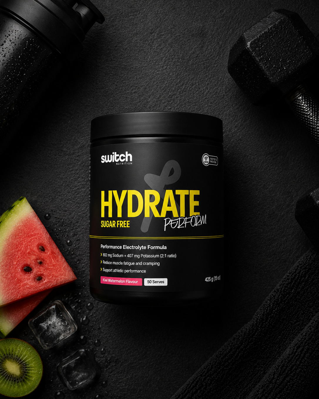 Hydrate supplement container with watermelon, kiwi, and dumbbells on a dark surface
