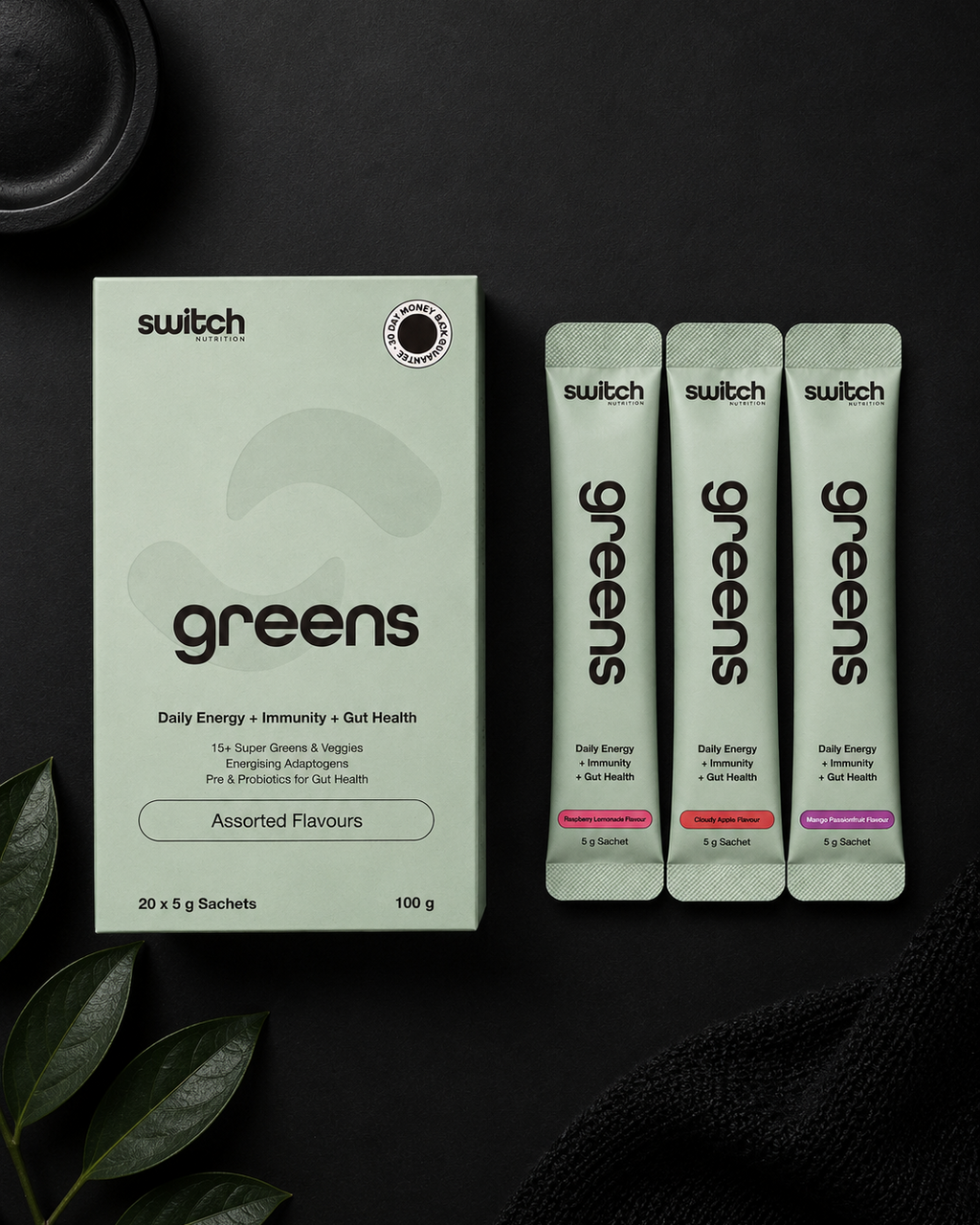 Switch greens supplement packaging on a dark background with leaves.