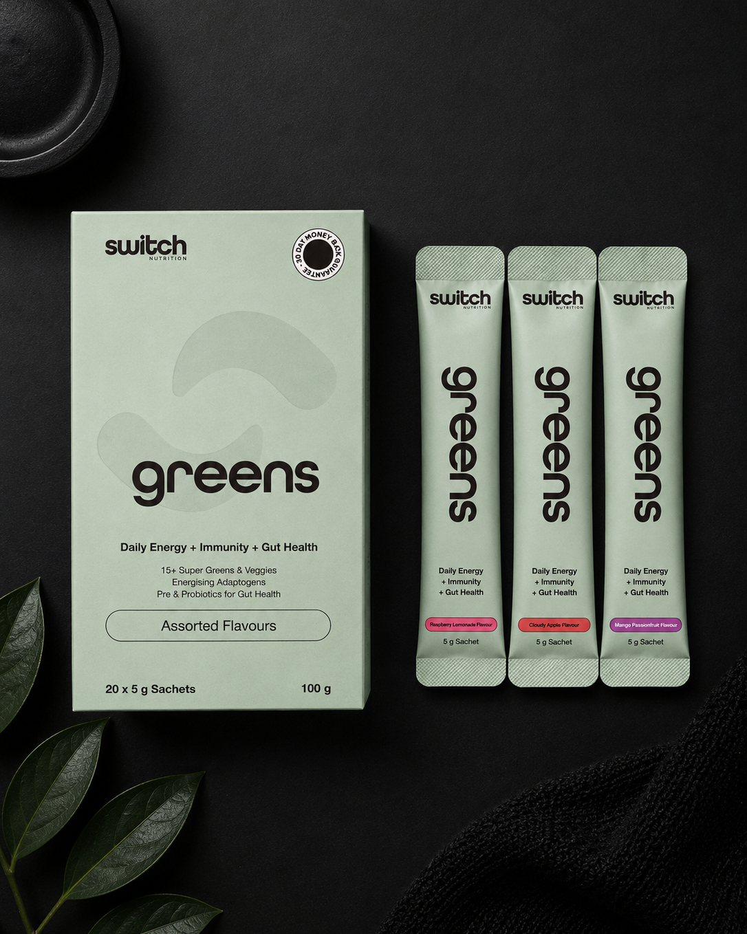 Switch greens supplement packaging on a dark background with leaves.