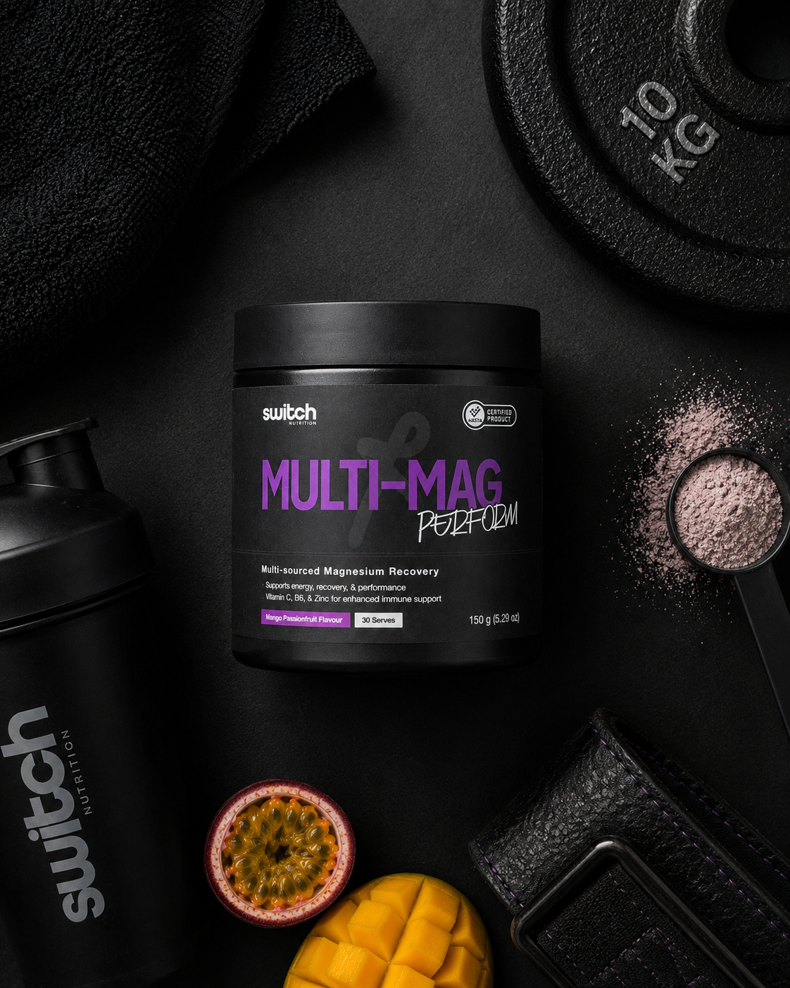 Multivitamin supplement container labeled 'Multi-Mag' on a dark surface with fitness equipment and fruits.