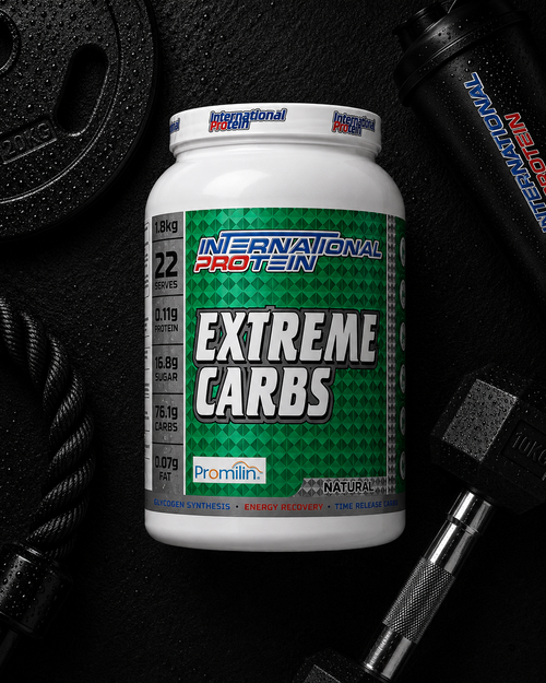 International Protein Extreme Carbs supplement container on a gym equipment background