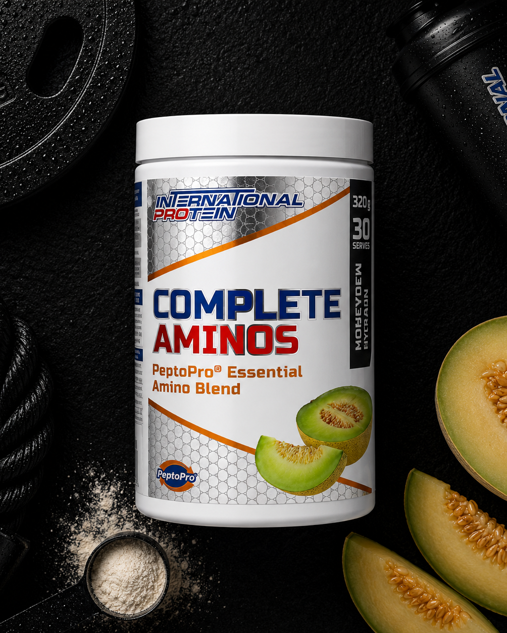 International Protein Complete Aminos supplement container with melon slices on a dark background