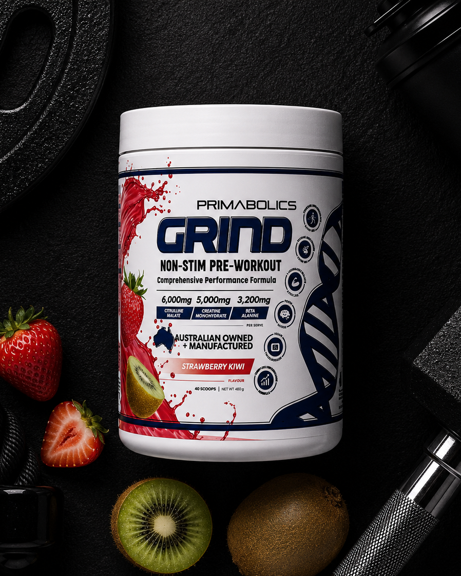 Primabolics Grind pre-workout supplement container with strawberries and kiwis on a dark background