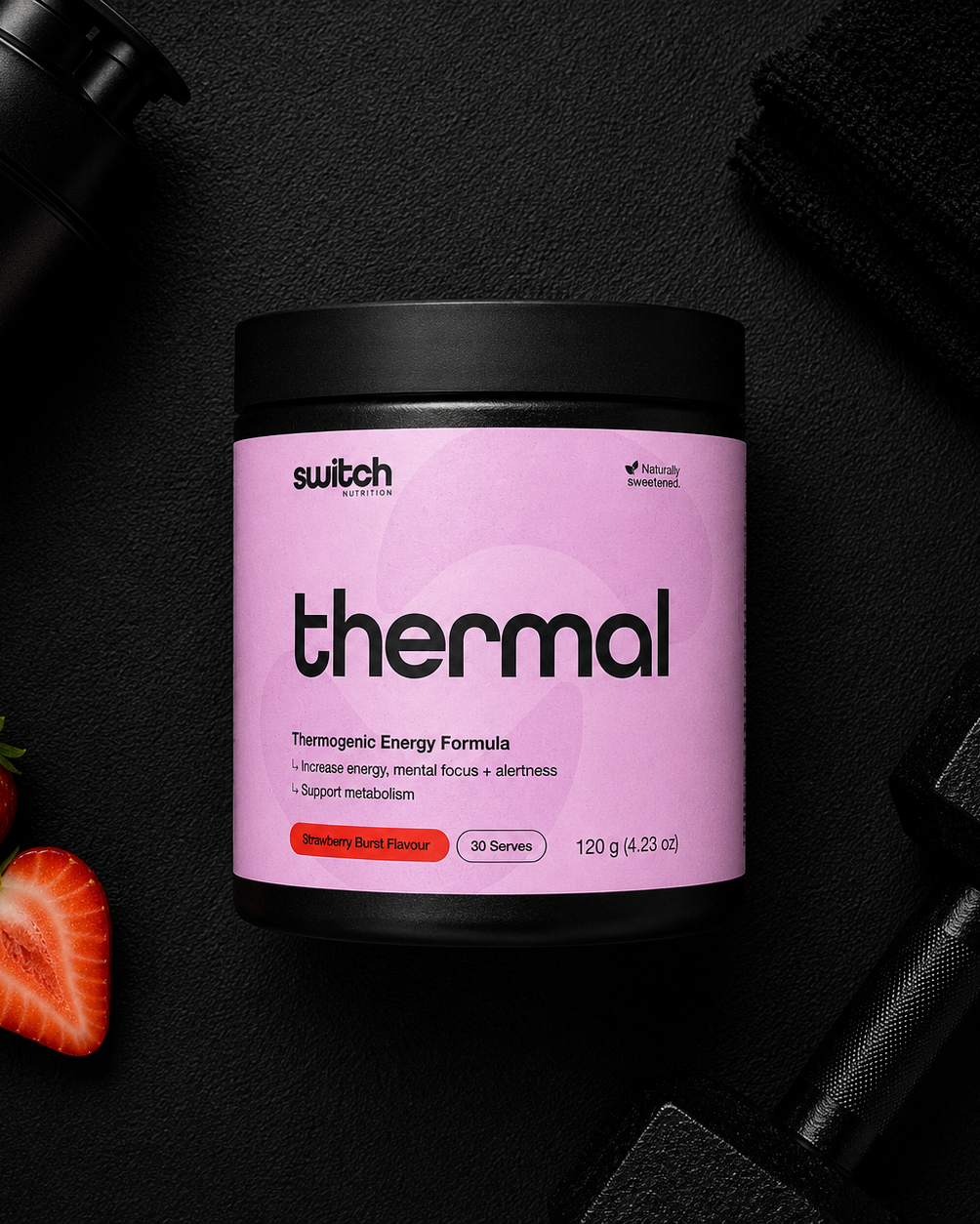 Pink supplement container labeled 'thermal' by 'switch' on a dark background with strawberries and a shaker.