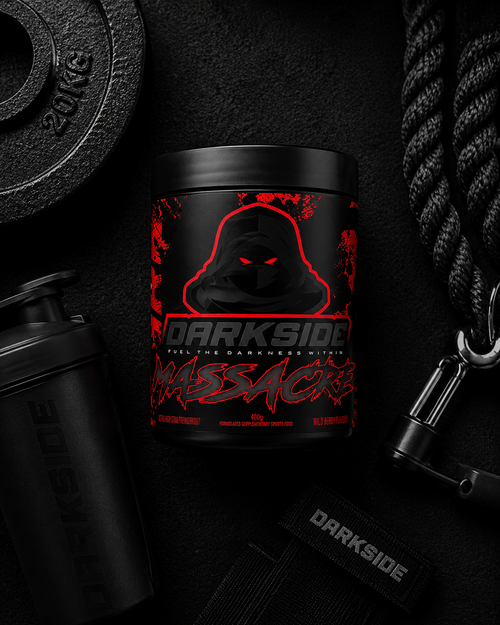 Black supplement container with red text on a dark background with fitness equipment.